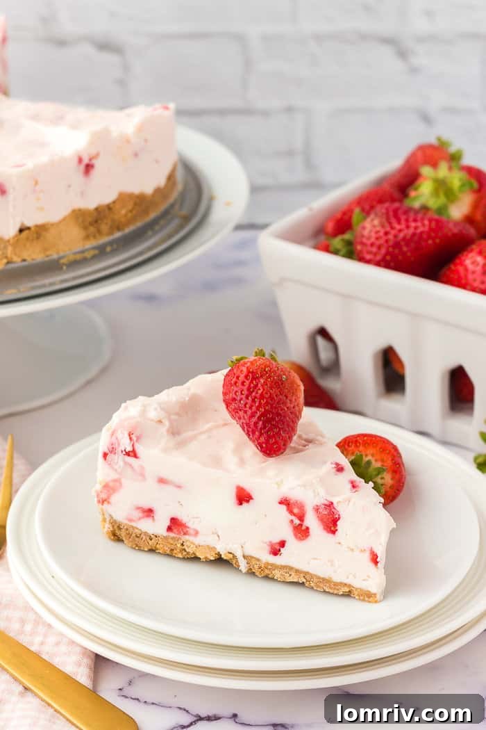 A pristine slice of no-bake strawberry cheesecake on a plate, ready to be enjoyed.