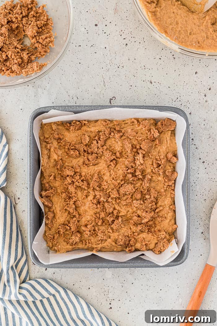 Chai crumble sprinkled over the first batter layer