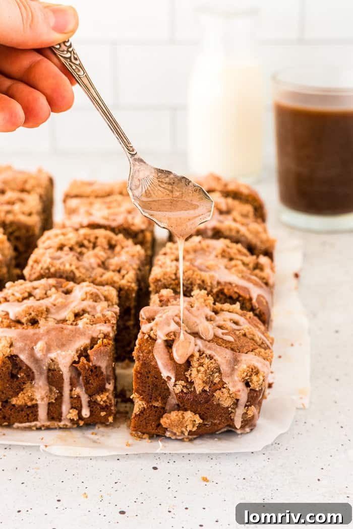 Close-up of chai coffee cake with glaze drizzled over crumble