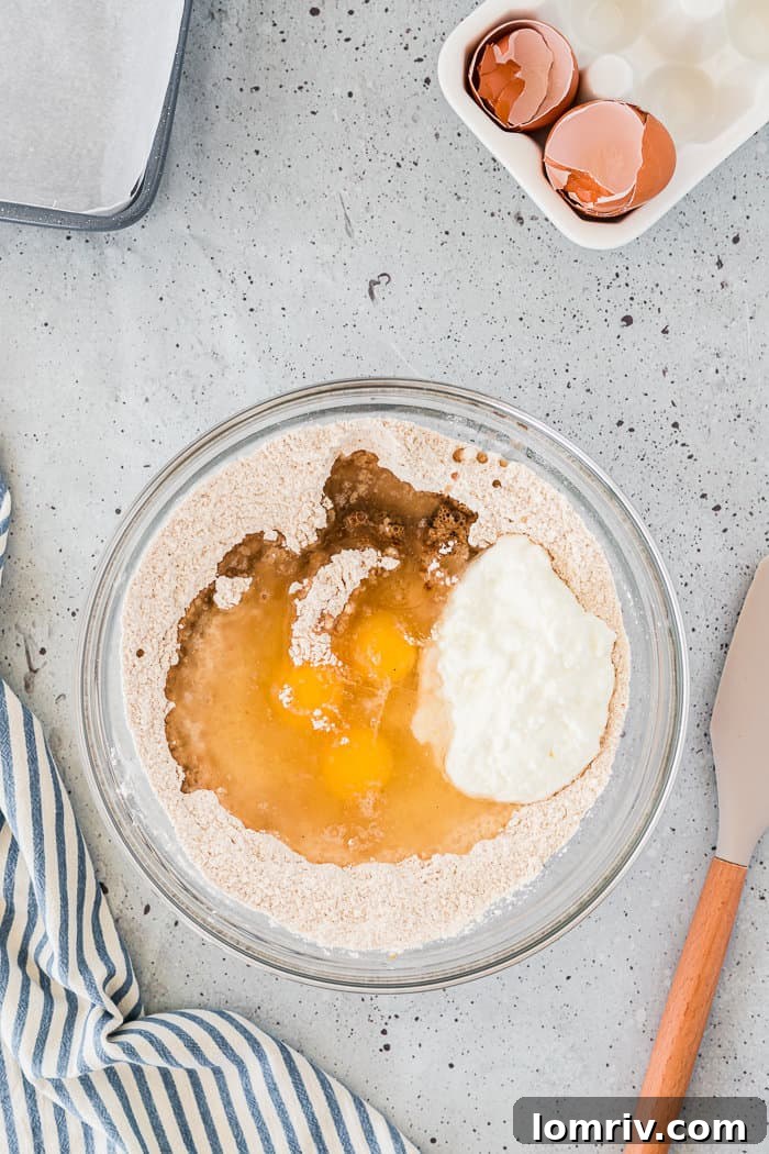 Adding wet ingredients to dry ingredients for chai coffee cake