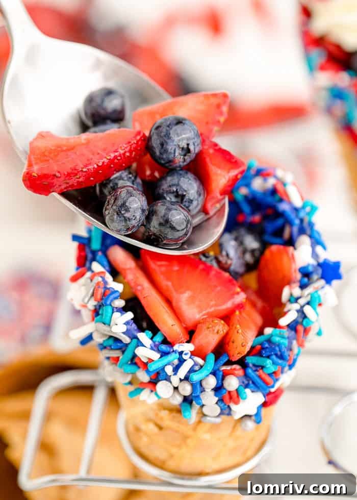 Fresh berries added on top of the cheesecake layer in a waffle cone.