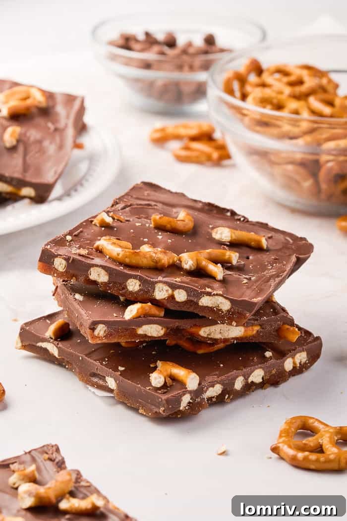 Beautifully stacked pieces of pumpkin bark, showcasing the layers of chocolate, pretzels, and toffee, ready to be served.