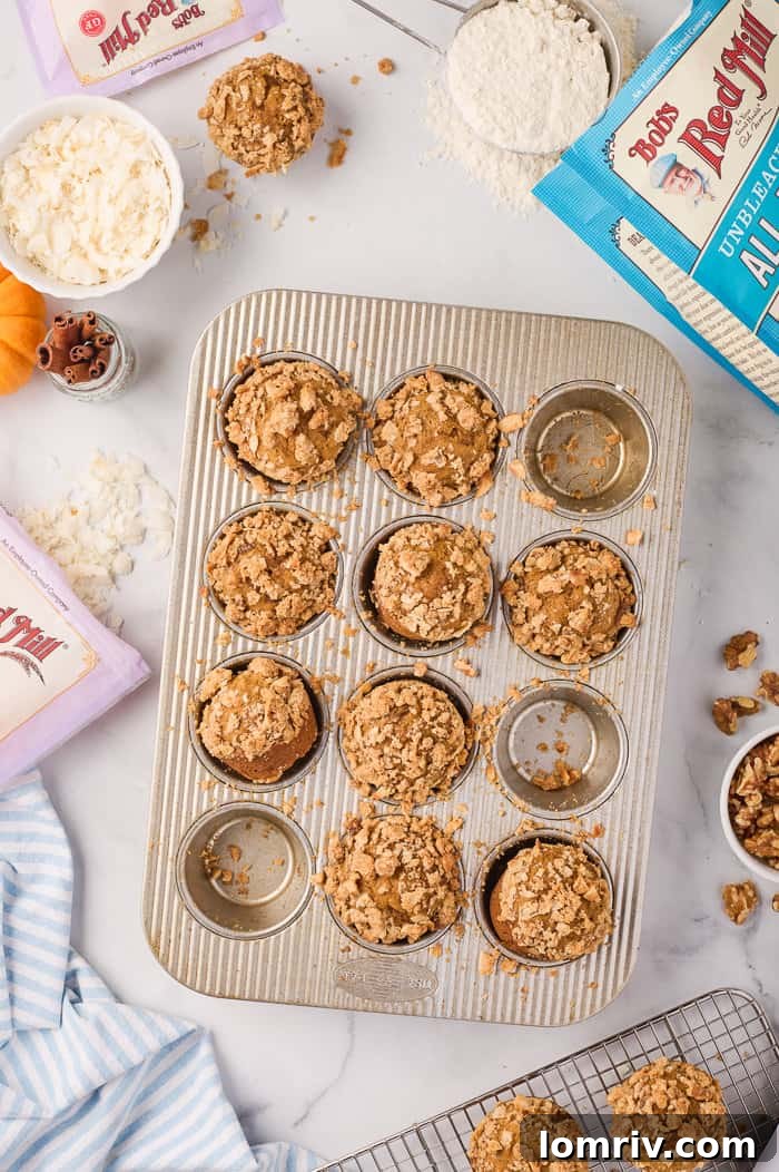 Warm pumpkin muffins arranged on a cooling rack, steam gently rising.