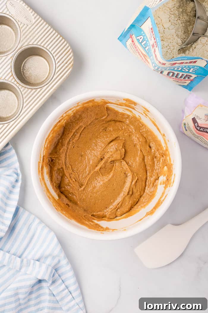 Pumpkin muffin batter in a bowl, showing its thick, uniform consistency.