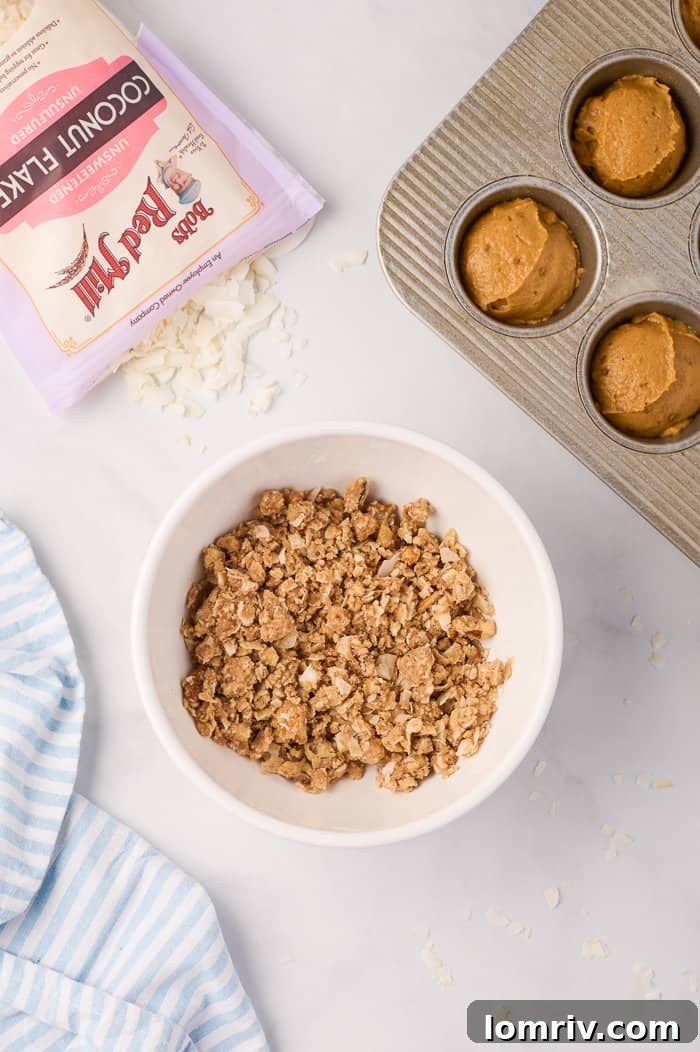 Streusel topping mixture in a bowl, showing its crumbly texture with nuts and coconut flakes.