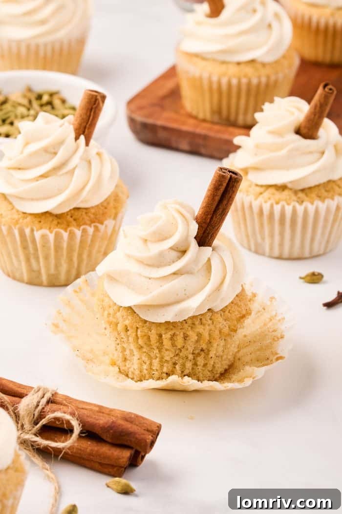 A single chai cupcake, unwrapped from its liner, showcasing its perfect dome and rich color.