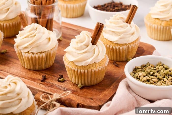 A beautifully arranged selection of chai cupcakes on a wooden cutting board, ready to be served and enjoyed.