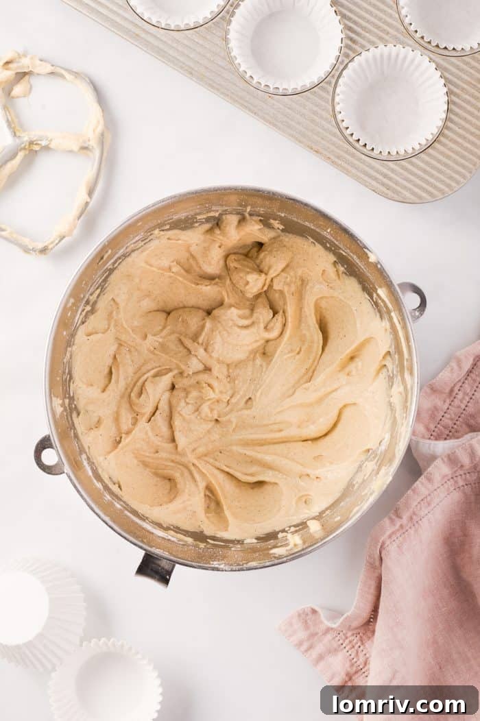 The cupcake batter, a rich, smooth consistency, ready to be scooped into liners.