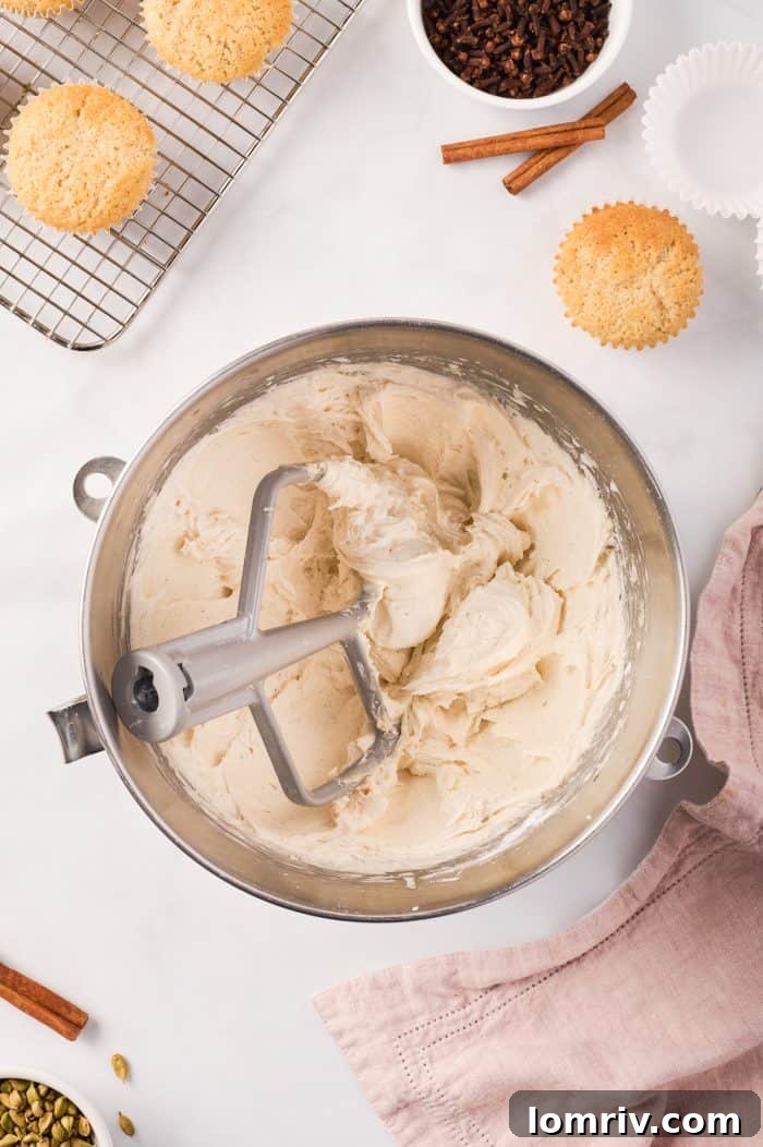 A bowl of rich, fluffy chai buttercream frosting, perfectly whipped and ready to adorn the cupcakes.