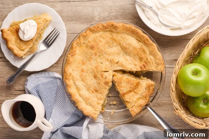 A Maple Cream Apple Pie with a single slice removed, revealing its delicious interior.