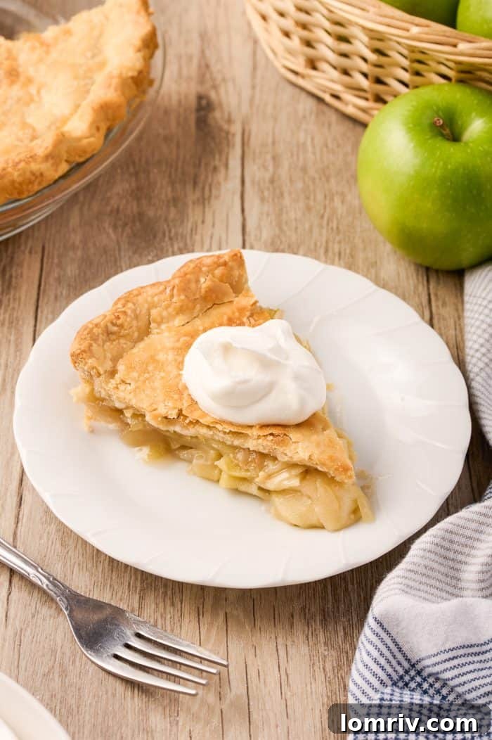 A close-up of a slice of Maple Cream Apple Pie, highlighting its texture and inviting appeal.