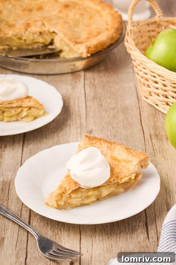 A perfect slice of Maple Cream Apple Pie, showcasing the rich, creamy filling and tender apple chunks.