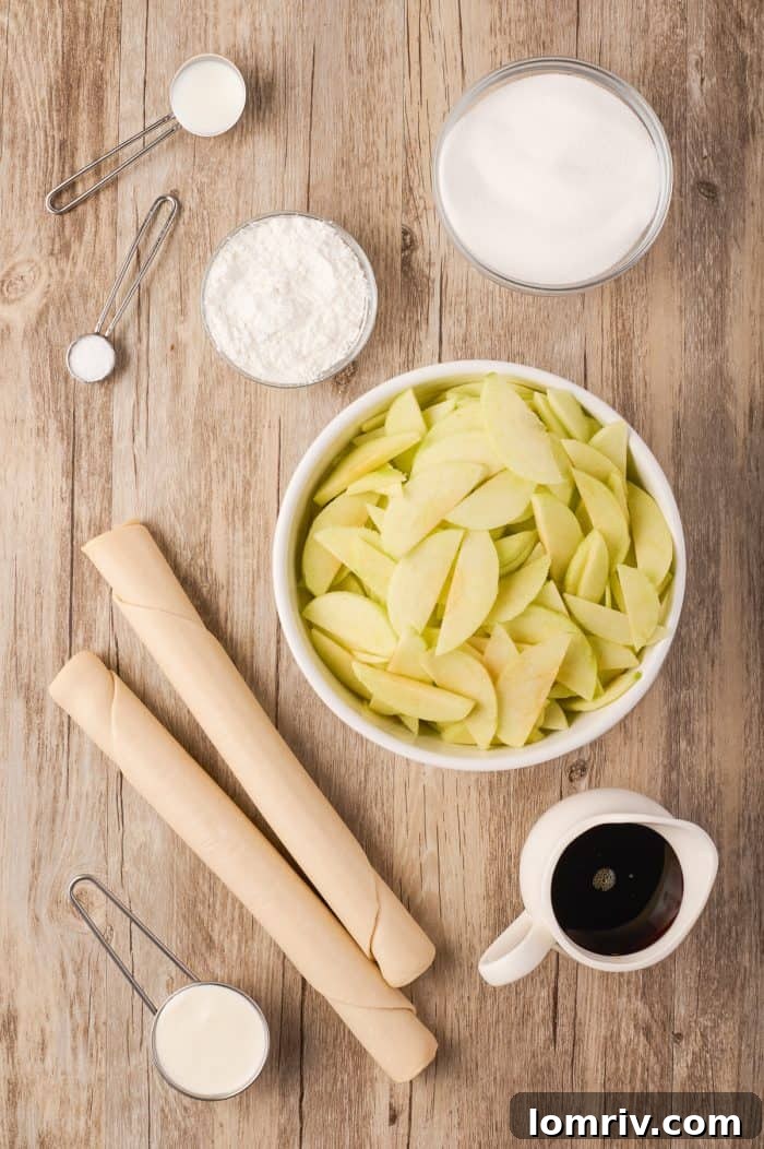 A display of the fresh ingredients needed to bake a Maple Cream Apple Pie, including apples, syrup, and cream.