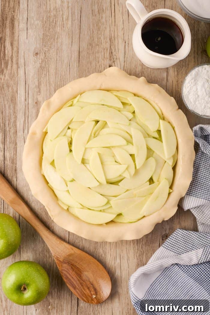 An unbaked Maple Cream Apple Pie, with a beautifully crimped crust, ready for the oven.