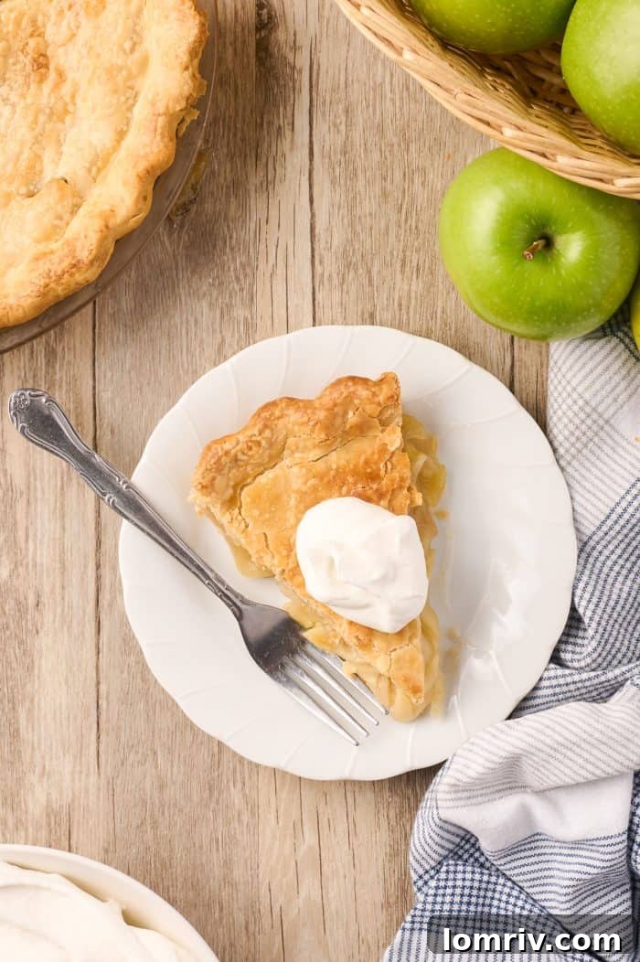 A beautifully presented slice of Maple Cream Apple Pie, ready to be enjoyed.