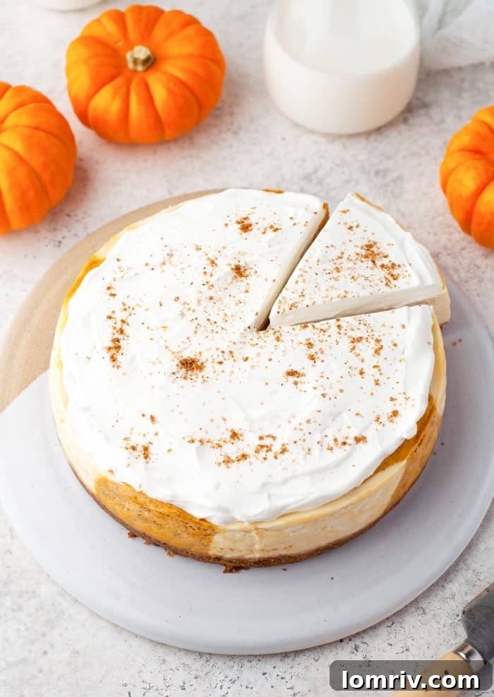 Instant pot pumpkin cheesecake with a slice cut into it.