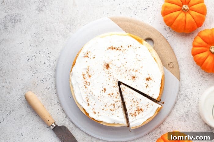 Instant pot pumpkin cheesecake with a slice cut into it.