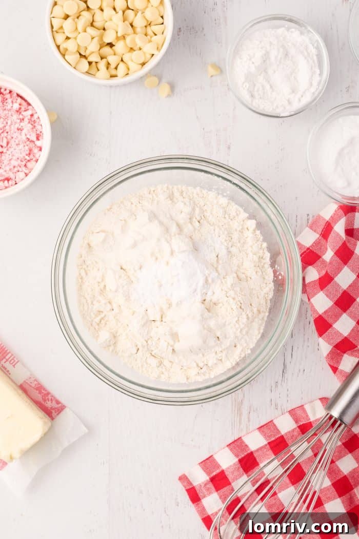 A bowl of dry ingredients (flour, baking soda, baking powder, salt) waiting to be mixed for the cookie dough.
