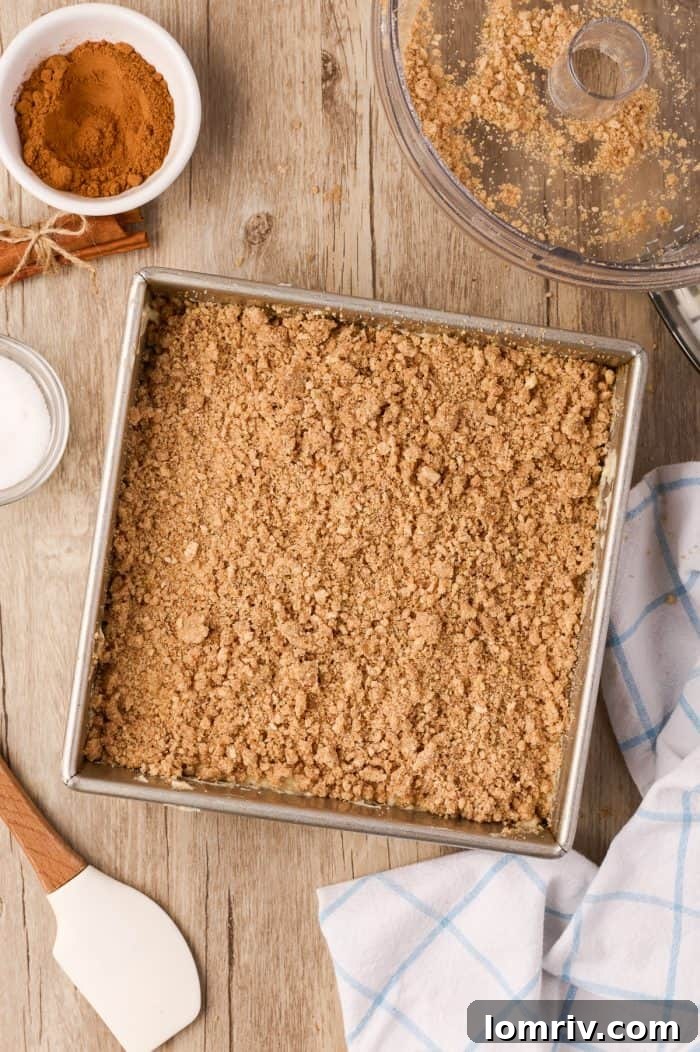 The fully assembled, unbaked sour cream coffee cake with all layers of batter and streusel.