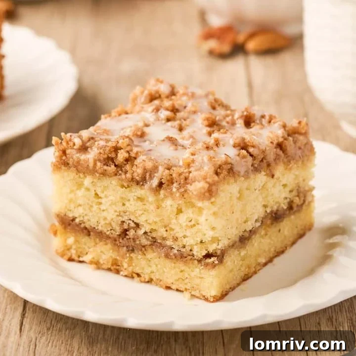 A slice of sour cream coffee cake on a plate.