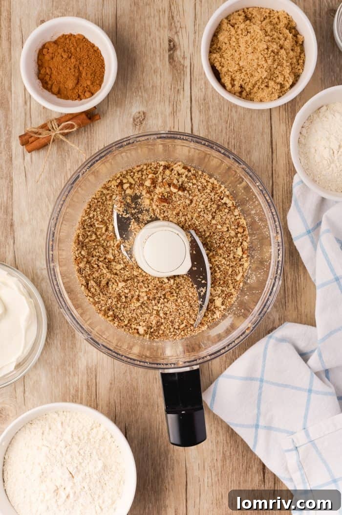 Streusel ingredients being combined in a food processor, illustrating the first step of preparation.
