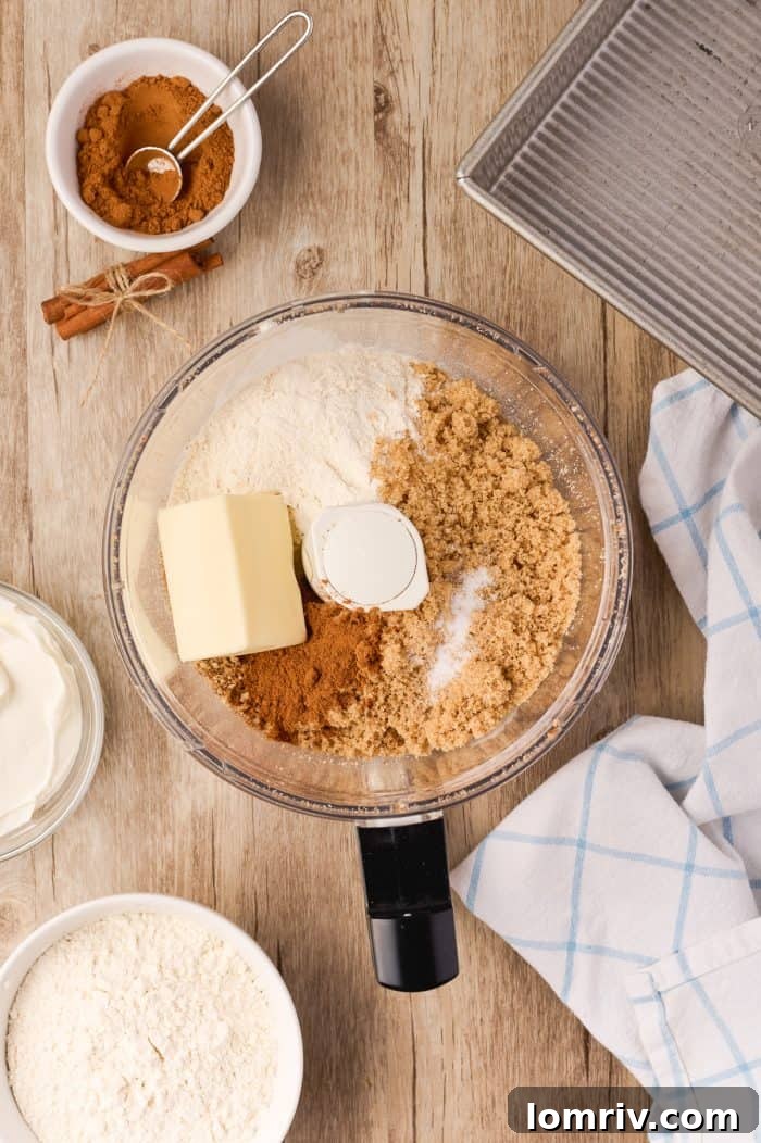 The streusel mixture transferred to a bowl, showing its crumbly texture after processing.