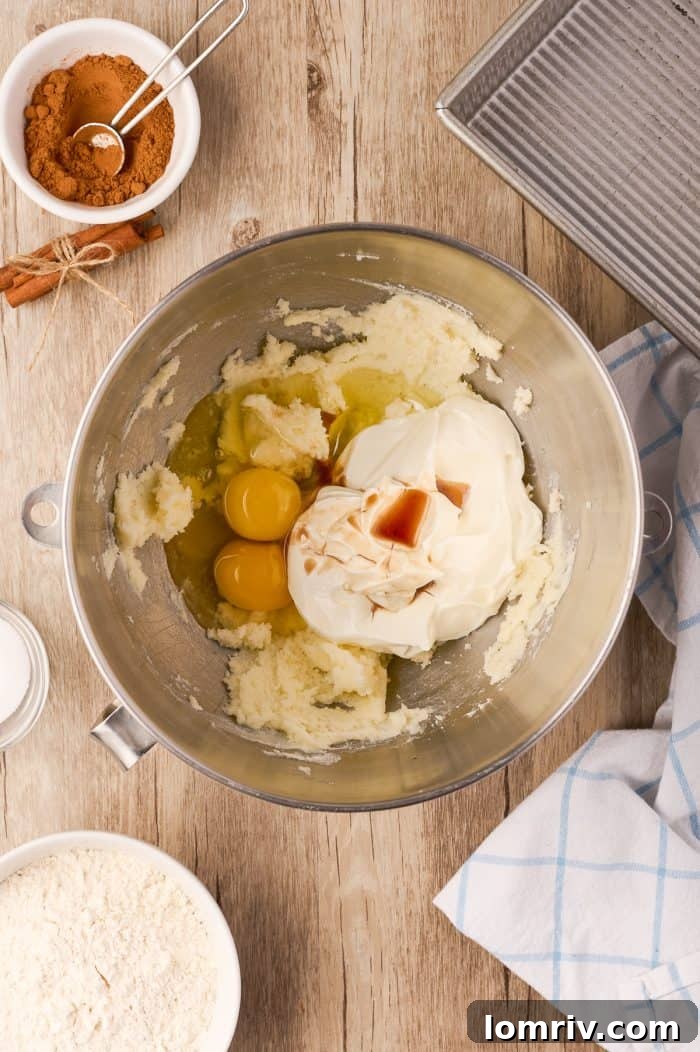 The cake batter with eggs, vanilla, and sour cream added, mixed to a smooth consistency.