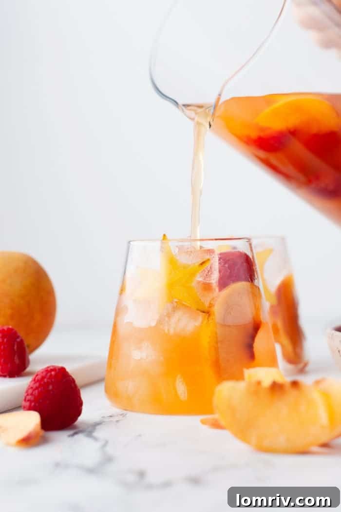 Serving peach sangria in glasses.