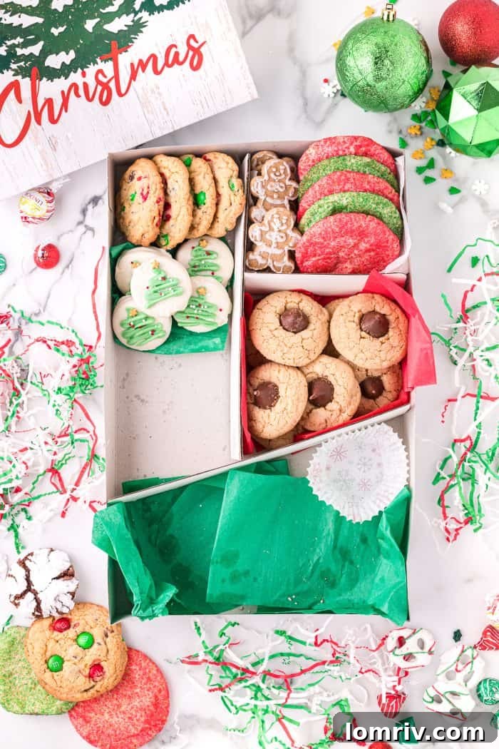 The process of filling a holiday cookie box with a variety of baked goods.
