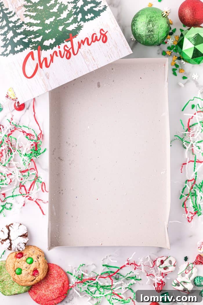 An empty holiday cookie box with sides taped.