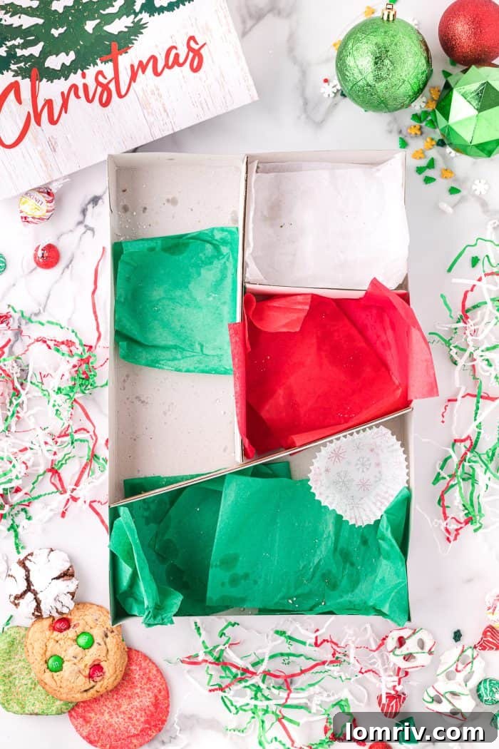 An empty holiday cookie box lined with tissue paper.