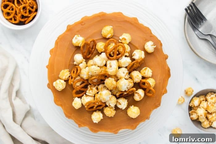 A detailed close-up of the no-bake caramel cheesecake, highlighting the lush texture of the filling and the caramel drizzle.