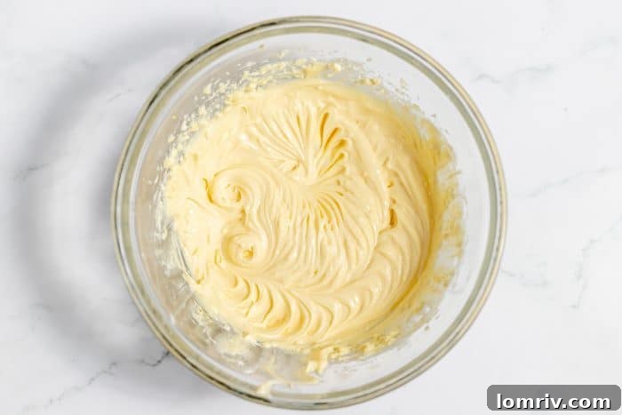 Smooth and creamy cheesecake filling ready to be added to the brownies.