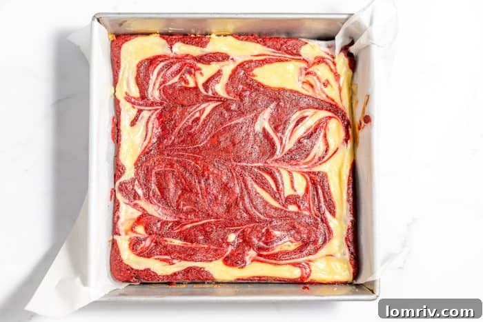 Freshly baked red velvet cheesecake brownies, just out of the oven with golden edges.