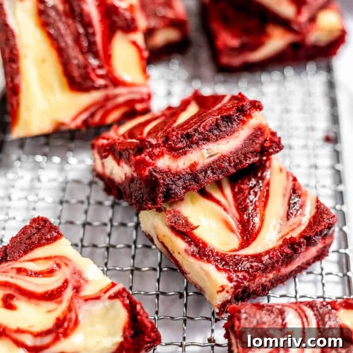 Red velvet cheesecake brownies cooling on a wire rack.