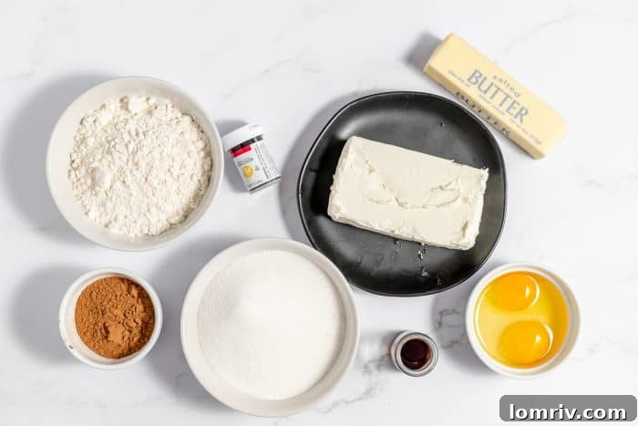Assortment of ingredients for red velvet cheesecake brownies displayed on a kitchen counter.