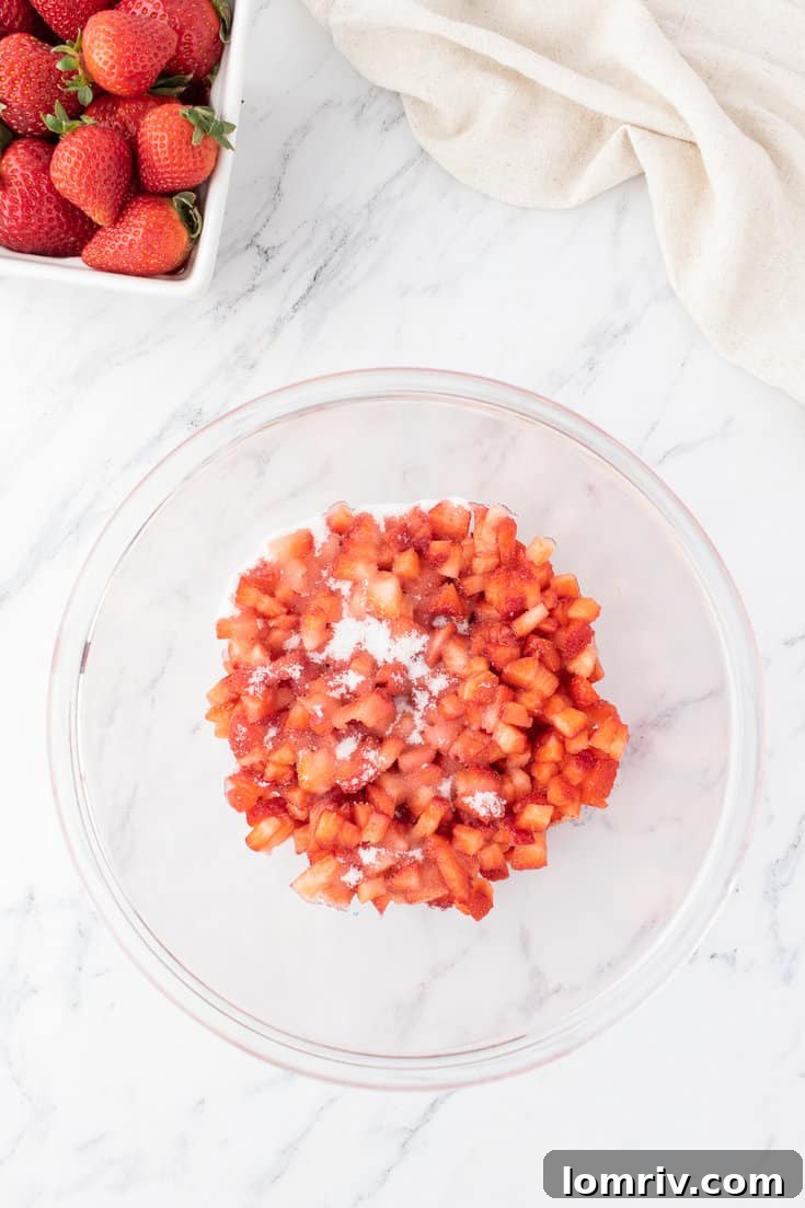 The strawberries in a bowl with sugar.