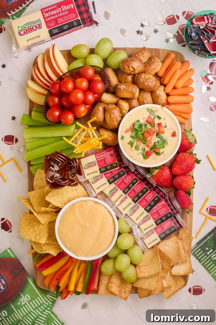 Game Day charcuterie board featuring an array of snacks and two delicious cheese dips.