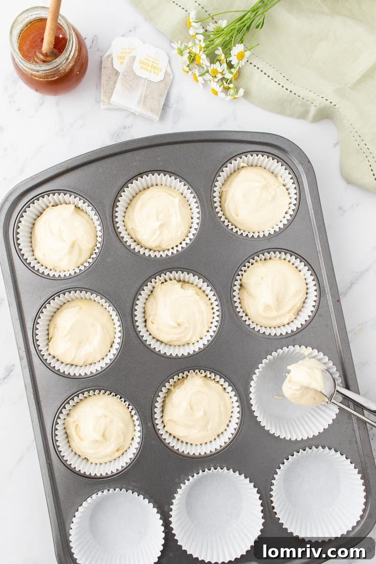 Filling the cupcake tray with cupcake batter.