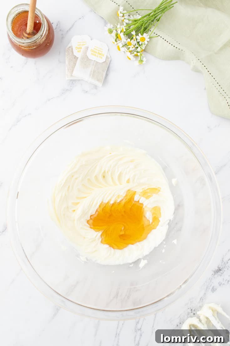 Beating the butter until creamy and adding honey.
