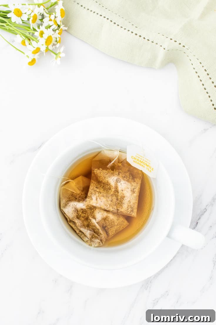Steeping the tea bags in hot water.