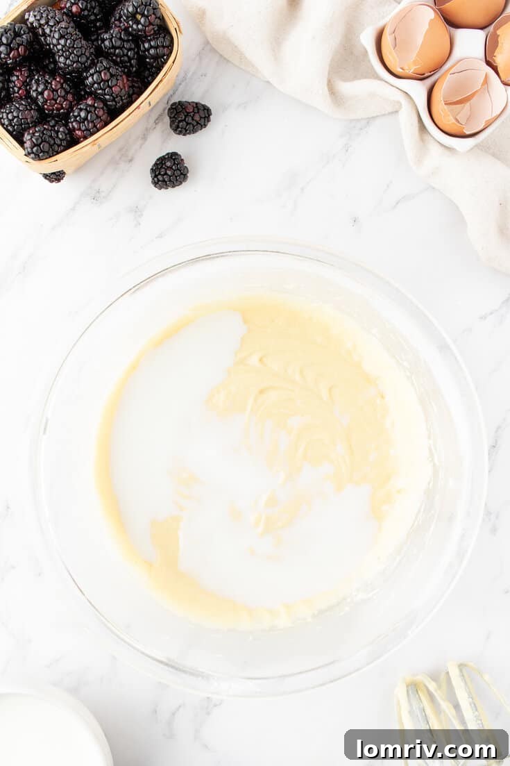 Smooth cake batter in a large mixing bowl, ready for baking.