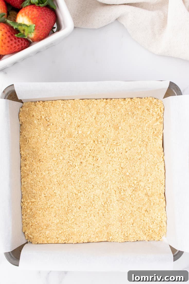Cheesecake crust pressed into a baking pan. 