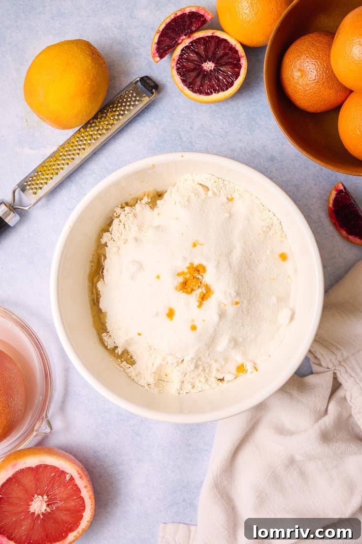 Adding zest and flour to the crust.