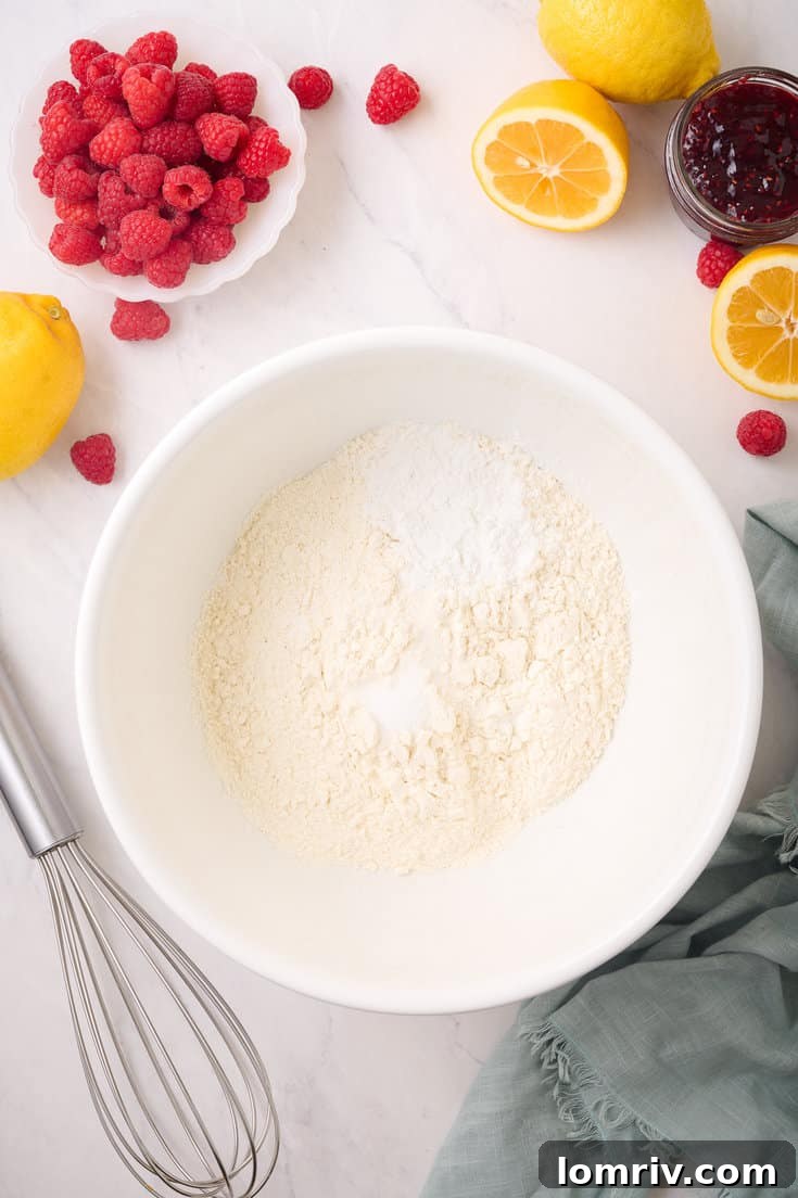 Dry ingredients for the lemon cake, including all-purpose flour, baking powder, and a pinch of salt, thoroughly whisked together in a medium bowl.