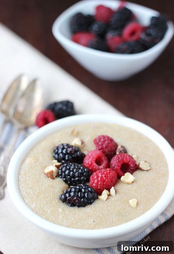 Overhead view of Amaranth Pudding garnished with fresh berries and crushed hazelnuts