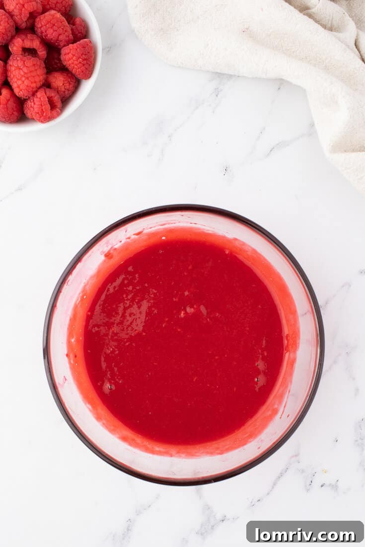 Thickened raspberry puree chilling in a bowl in the refrigerator