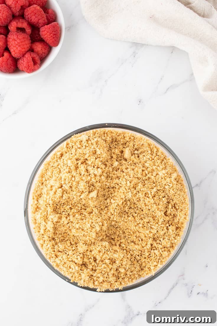 Mixing graham cracker crumbs, sugar, and melted butter for the crust