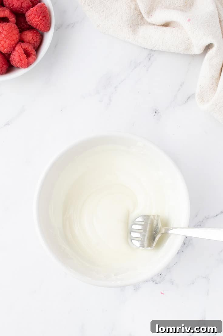 White chocolate chips melting in a bowl for the ganache