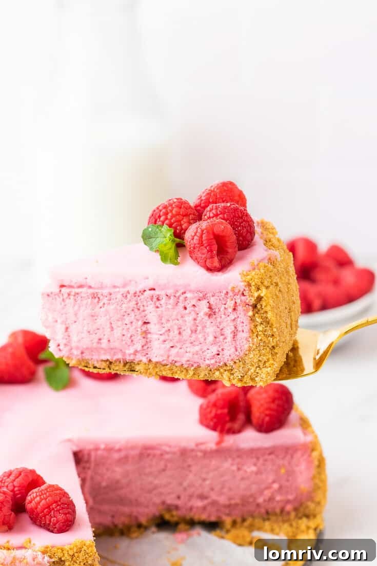 Raspberry Cheesecake adorned with fresh raspberries and mint leaves